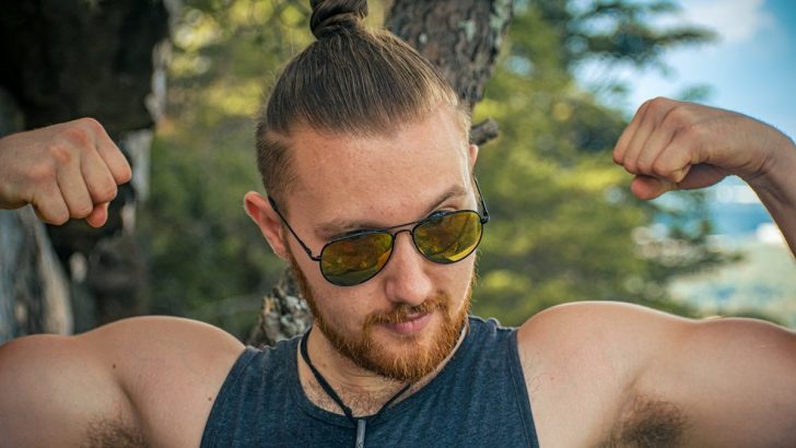 Buff male flexing on top of mountain
